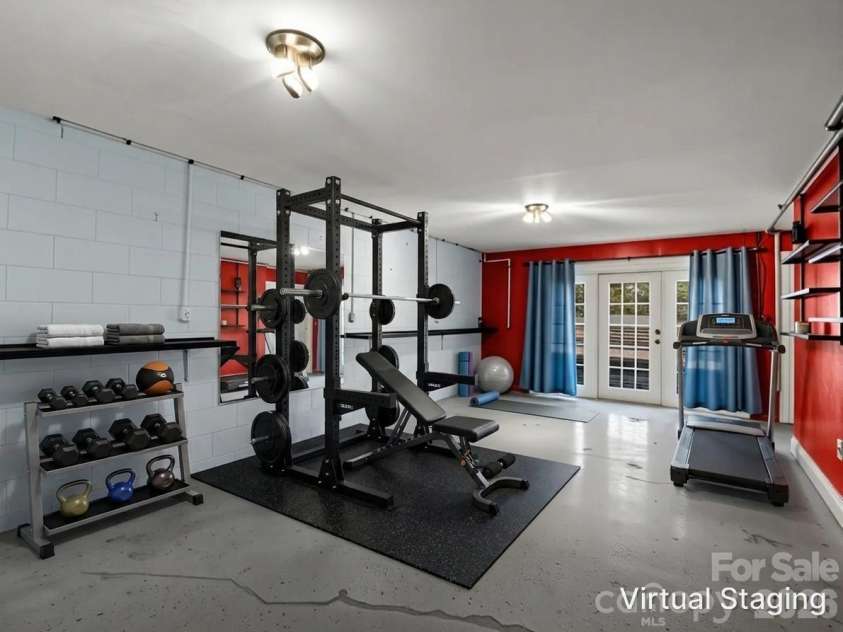 1867 Fruitland Road, Hendersonville, NC 28792.  MLS# CAR4322794, YatesRealty ID 18363. Additional lower level space virtually staged as a home gym