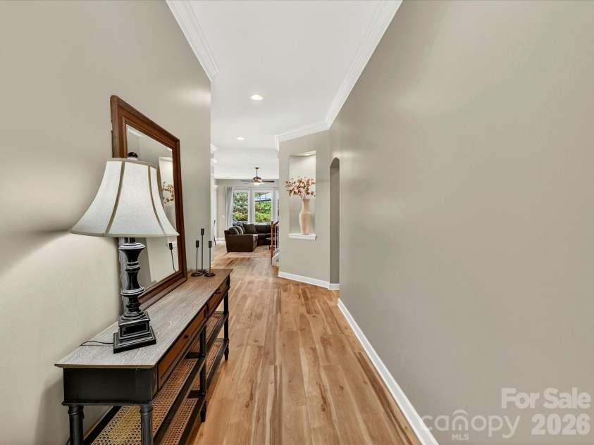 18721 The Commons Boulevard, Cornelius, NC 28031.  MLS# CAR4373232, YatesRealty ID 18371. Bright and welcoming entryway featuring stylish flooring, crown molding, and a spacious layout that flows seamlessly into the main living areas.