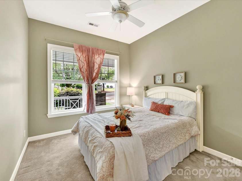 18721 The Commons Boulevard, Cornelius, NC 28031.  MLS# CAR4373232, YatesRealty ID 18371. Charming fourth bedroom featuring soft carpeting, vaulted ceilings, and abundant natural light for a bright and welcoming retreat.