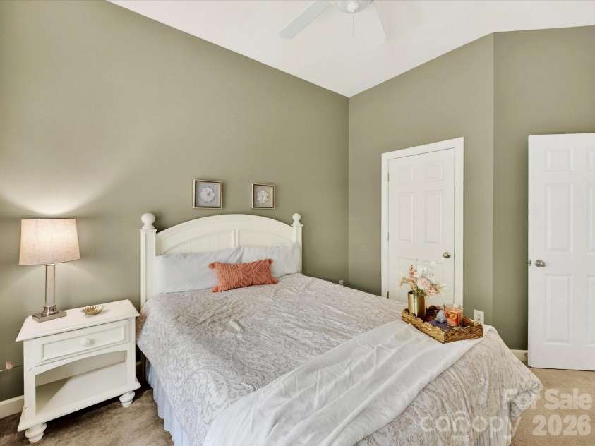 18721 The Commons Boulevard, Cornelius, NC 28031.  MLS# CAR4373232, YatesRealty ID 18371. Charming fourth bedroom featuring soft carpeting, vaulted ceilings, and abundant natural light for a bright and welcoming retreat.