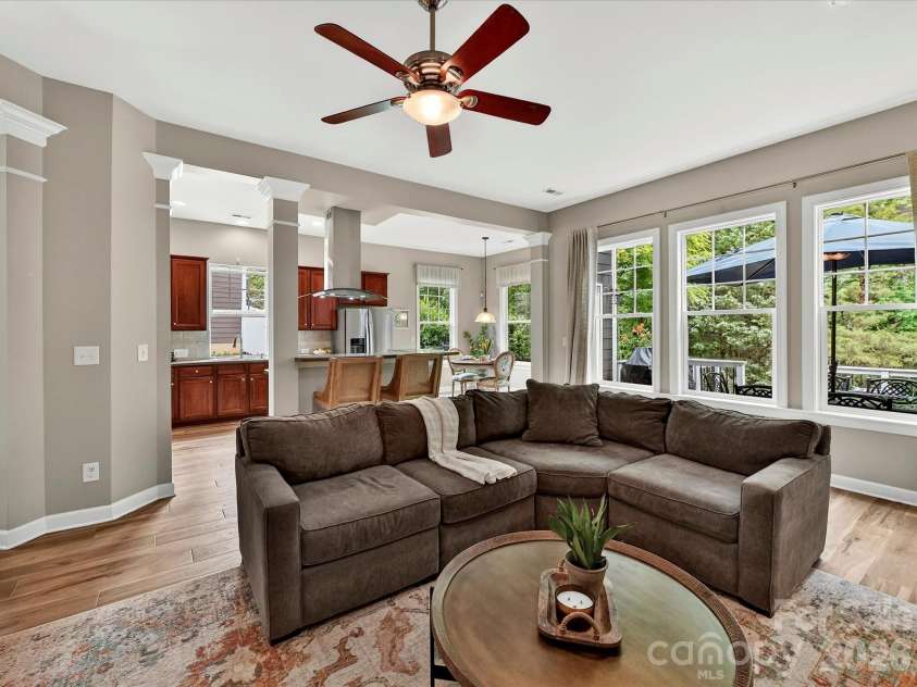 18721 The Commons Boulevard, Cornelius, NC 28031.  MLS# CAR4373232, YatesRealty ID 18371. Open-concept great room featuring warm LVP flooring, a statement fireplace, and seamless flow to surrounding living spaces—ideal for everyday living and entertaining.
