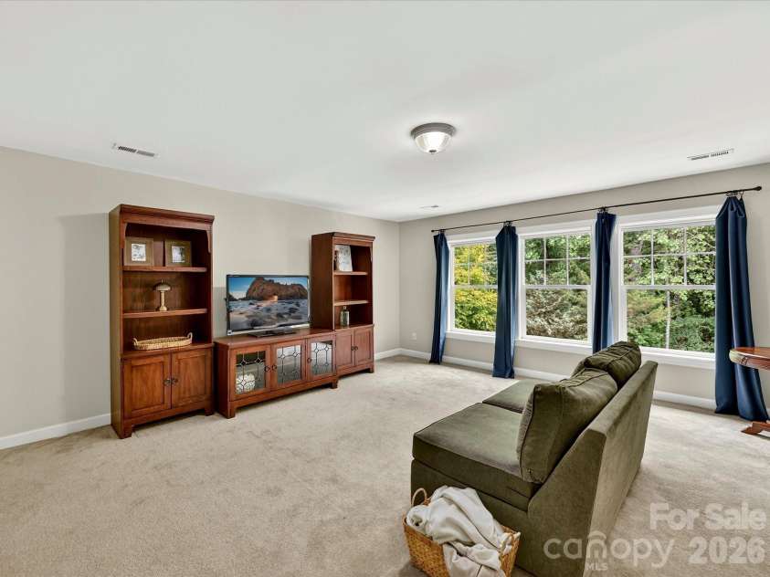18721 The Commons Boulevard, Cornelius, NC 28031.  MLS# CAR4373232, YatesRealty ID 18371. Spacious bonus room filled with natural light, offering versatile space ideal for a media room, playroom, or home office.