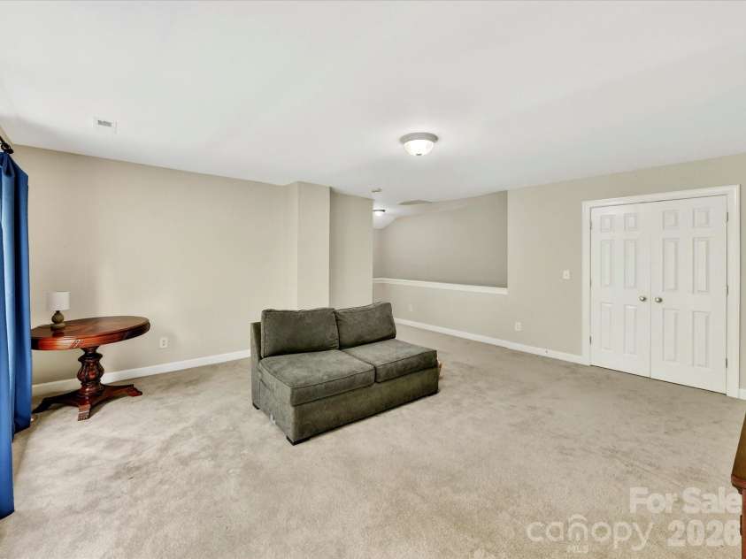 18721 The Commons Boulevard, Cornelius, NC 28031.  MLS# CAR4373232, YatesRealty ID 18371. Spacious bonus room filled with natural light, offering versatile space ideal for a media room, playroom, or home office.