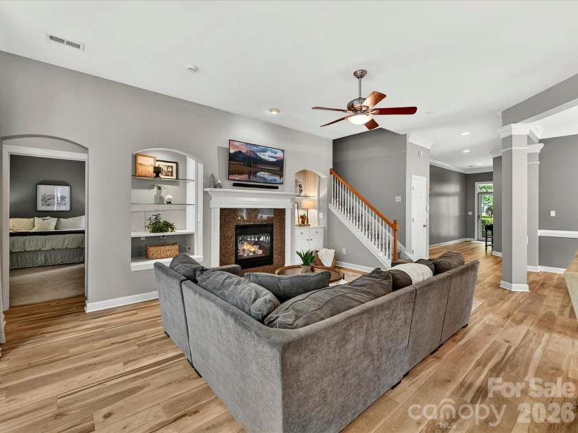 18721 The Commons Boulevard, Cornelius, NC 28031.  MLS# CAR4373232, YatesRealty ID 18371. Spacious great room with abundant natural light, cozy fireplace, custom built-ins, and an open layout perfect for relaxing or entertaining.