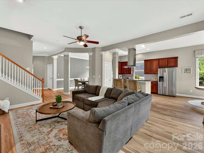 18721 The Commons Boulevard, Cornelius, NC 28031.  MLS# CAR4373232, YatesRealty ID 18371. Spacious great room with abundant natural light, cozy fireplace, custom built-ins, and an open layout perfect for relaxing or entertaining.