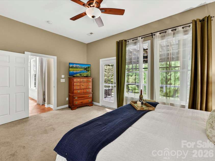 18721 The Commons Boulevard, Cornelius, NC 28031.  MLS# CAR4373232, YatesRealty ID 18371. Spacious primary suite featuring vaulted ceilings, abundant natural light, and a private ensuite—creating a peaceful retreat.