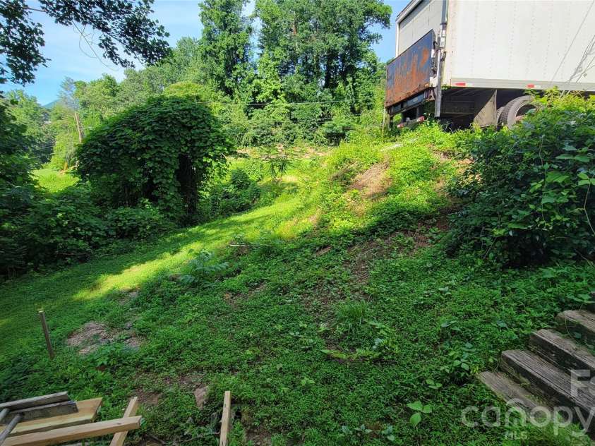 160 Cleveland Road, Tryon, NC 28782.  MLS# CAR4274322, YatesRealty ID 1838. Looking over right lots from basement