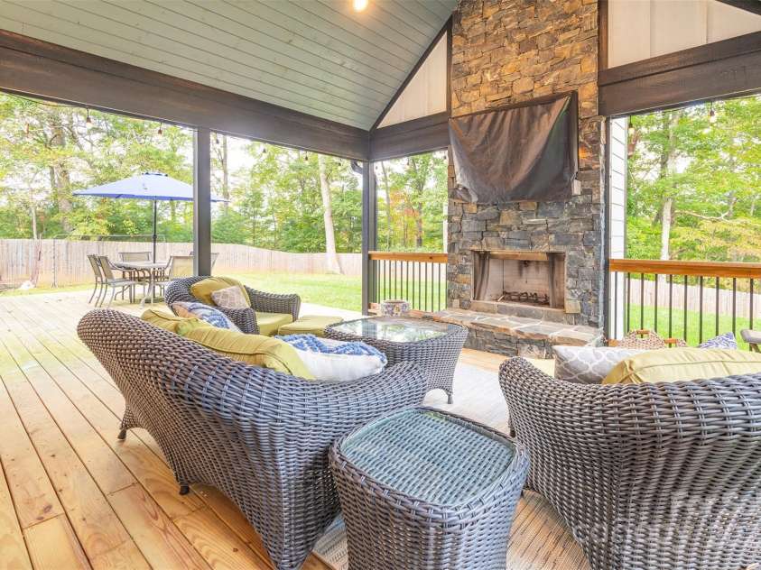 45 Erin Glen Court, Fairview, NC 28730.  MLS# CAR4239316, YatesRealty ID 18382. Covered back deck with wood burning fireplace leading to sun deck and expansive, fenced back yard