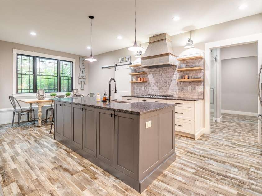 45 Erin Glen Court, Fairview, NC 28730.  MLS# CAR4239316, YatesRealty ID 18382. Kitchen with dining area. HUGE pantry to the left of the range