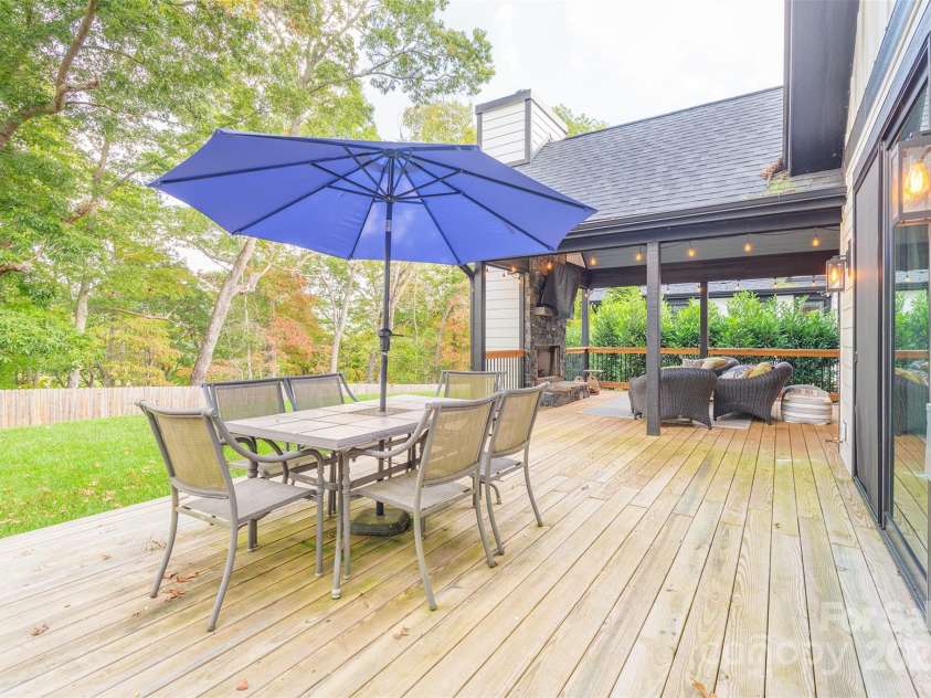 45 Erin Glen Court, Fairview, NC 28730.  MLS# CAR4239316, YatesRealty ID 18382. Sun deck off of primary bedroom looking toward covered back deck