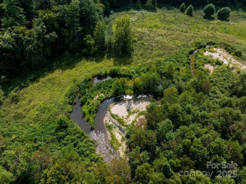 721 Kuenzel Eller Drive, Millers Creek, NC 28651.  MLS# CAR4179124, YatesRealty ID 184. Middle Fork of Reddies River runs through the lower 28 acres of farm land