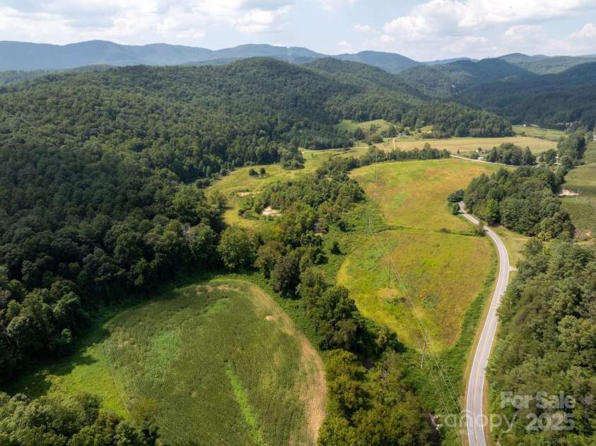 721 Kuenzel Eller Drive, Millers Creek, NC 28651.  MLS# CAR4179124, YatesRealty ID 184. Mountains in the distance and farmland from up high