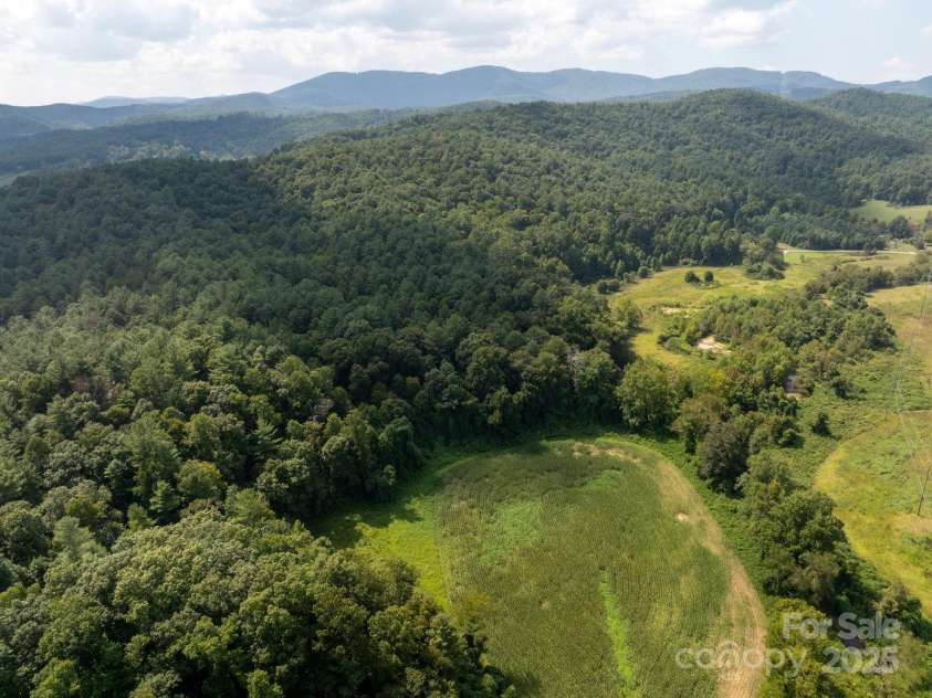 721 Kuenzel Eller Drive, Millers Creek, NC 28651.  MLS# CAR4179124, YatesRealty ID 184. Mountains with clouds making shadows on the land