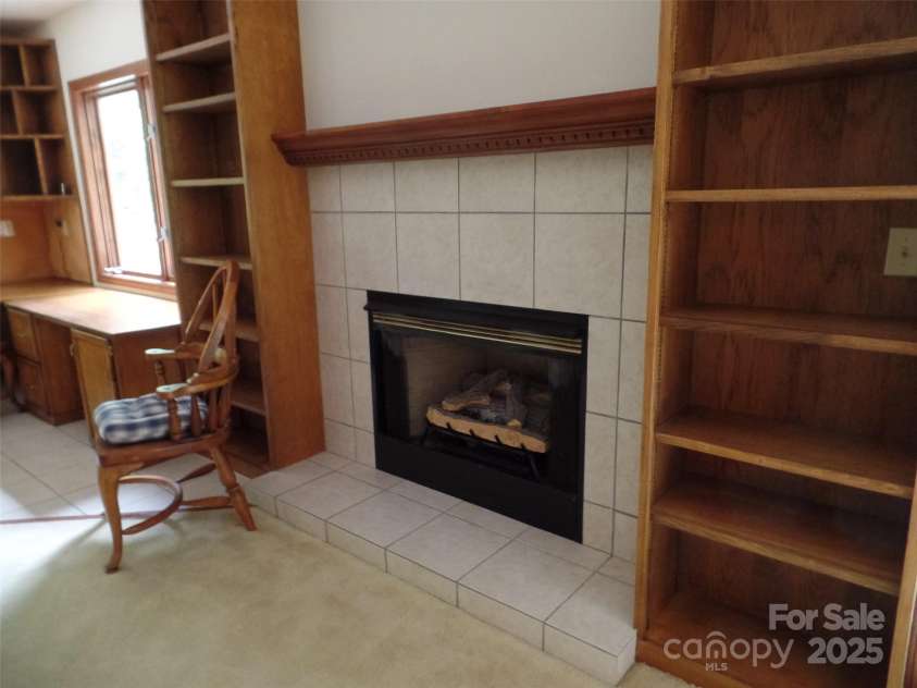 721 Kuenzel Eller Drive, Millers Creek, NC 28651.  MLS# CAR4179124, YatesRealty ID 184. Propane Fireplace with built-in bookshelves in Office Area