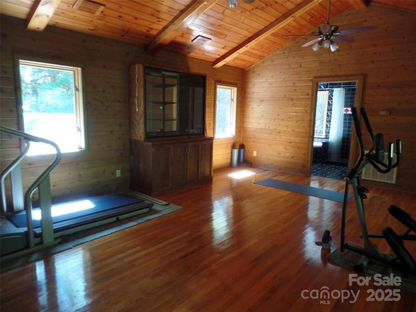 721 Kuenzel Eller Drive, Millers Creek, NC 28651.  MLS# CAR4179124, YatesRealty ID 184. Upper level Bedroom and exercise equipment with bathroom in the distance
