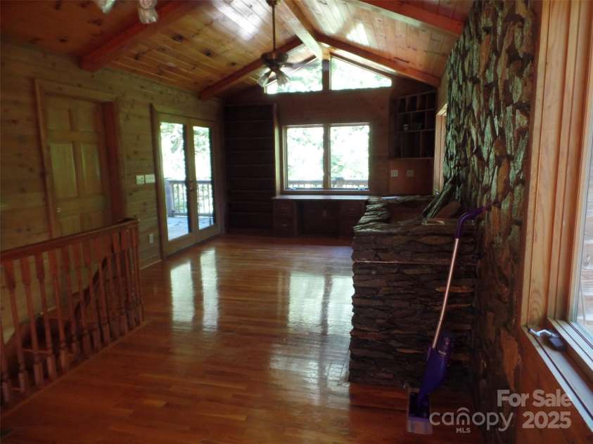 721 Kuenzel Eller Drive, Millers Creek, NC 28651.  MLS# CAR4179124, YatesRealty ID 184. Upper level Office with Stone Fireplace, Stairs to downstairs and doors to Deck
