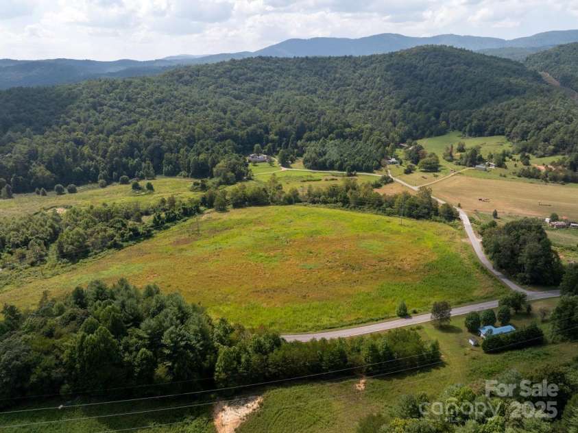 721 Kuenzel Eller Drive, Millers Creek, NC 28651.  MLS# CAR4179124, YatesRealty ID 184. View from Old Hwy 16 looking back toward farm land, River  and Mountain for the 134.9 Acres