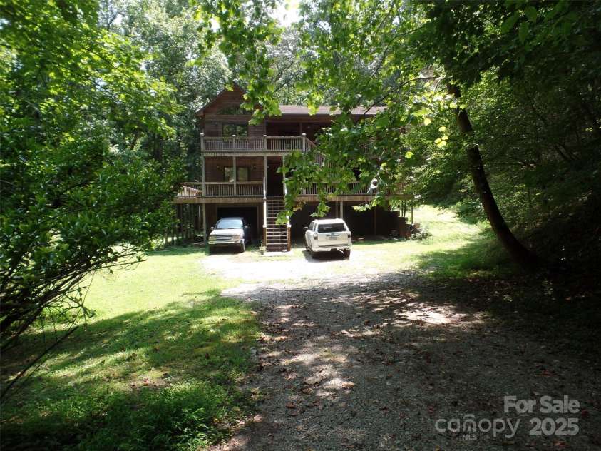 721 Kuenzel Eller Drive, Millers Creek, NC 28651.  MLS# CAR4179124, YatesRealty ID 184. View of home as you enter from Driveway with 3 car garage and covered area with space for 3 Car Carport or work area