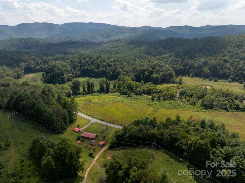 721 Kuenzel Eller Drive, Millers Creek, NC 28651.  MLS# CAR4179124, YatesRealty ID 184. View of Mountain and farm land from across Old Hwy 16 looking back toward Farm