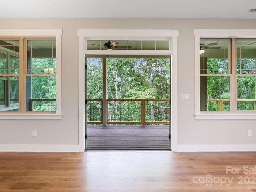 21 Craftsman Overlook Ridge, Arden, NC 28704.  MLS# CAR4007643, YatesRealty ID 18407. French doors open to large, covered Trex deck overlooking private wooded view.