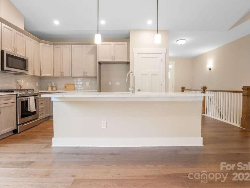21 Craftsman Overlook Ridge, Arden, NC 28704.  MLS# CAR4007643, YatesRealty ID 18407. Large kitchen island opens into great room