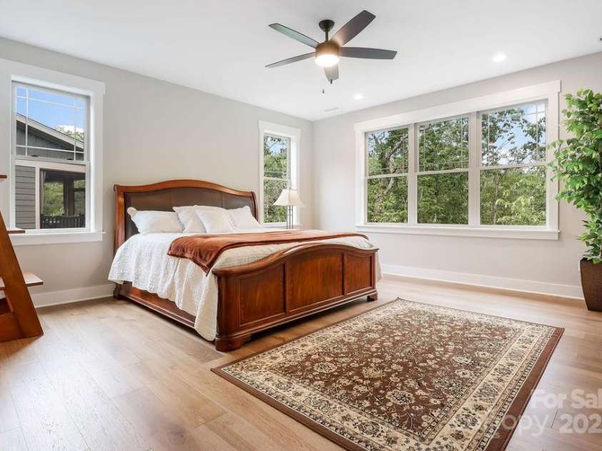 21 Craftsman Overlook Ridge, Arden, NC 28704.  MLS# CAR4007643, YatesRealty ID 18407. Primary suite features ceiling fans and lots of light and room for a king sized bed.