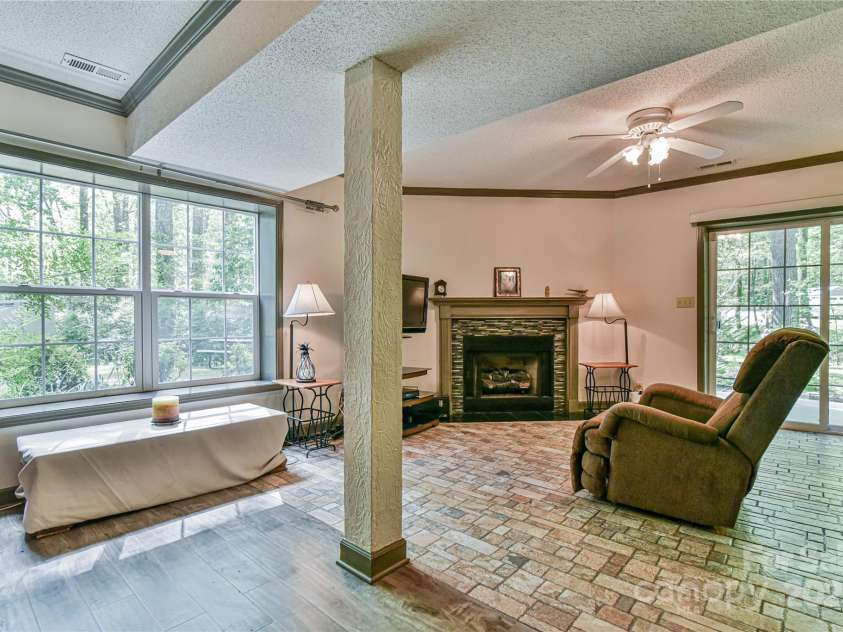 145 Fox Glen Drive, Arden, NC 28704.  MLS# CAR4134713, YatesRealty ID 18409. Daylight basement apartment living area from dining area.