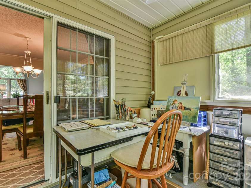 145 Fox Glen Drive, Arden, NC 28704.  MLS# CAR4134713, YatesRealty ID 18409. Enclosed porch great for art studio or craft room