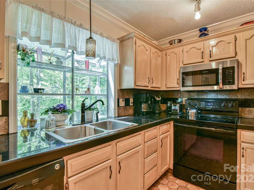 145 Fox Glen Drive, Arden, NC 28704.  MLS# CAR4134713, YatesRealty ID 18409. Kitchen garden box window to enjoy backyard views.