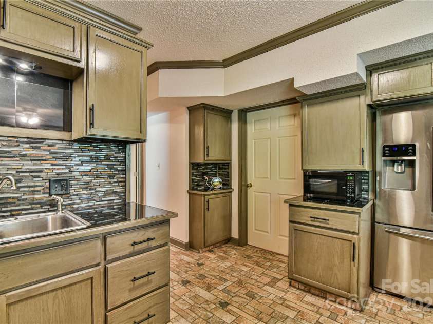 145 Fox Glen Drive, Arden, NC 28704.  MLS# CAR4134713, YatesRealty ID 18409. Plenty of cabinets in basement kitchen
