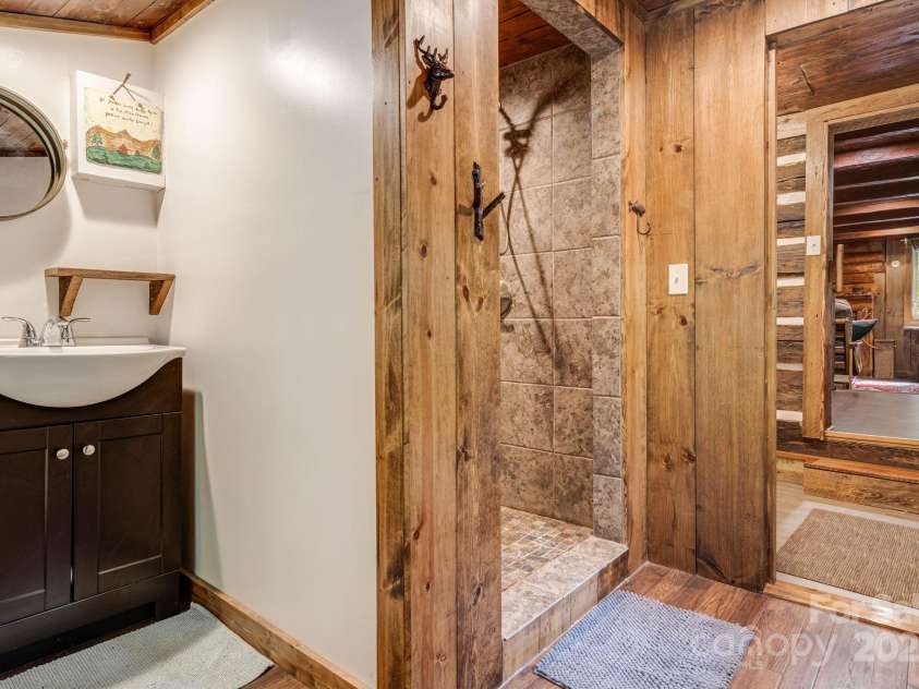 482 Pheasant Street, Lake Lure, NC 28746.  MLS# CAR4253575, YatesRealty ID 18417. Bathroom With Large Tile Shower