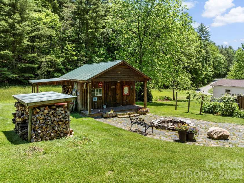 514 Roy Forrester Road, Mars Hill, NC 28754.  MLS# CAR4367162, YatesRealty ID 18420. Shed Fire Pit Back to Left