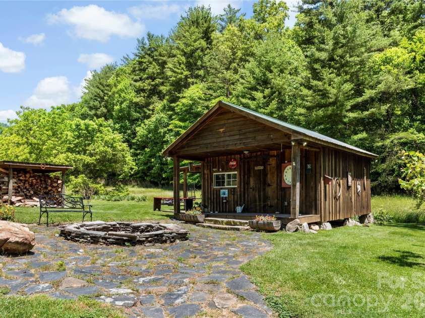 514 Roy Forrester Road, Mars Hill, NC 28754.  MLS# CAR4367162, YatesRealty ID 18420. Shed Front and Fire Pit