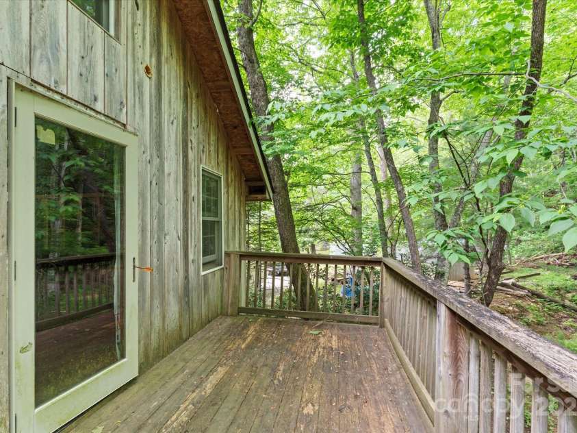23 Mountain Meadow Lane, Canton, NC 28716.  MLS# CAR4269164, YatesRealty ID 18435. Deck off the potential living space above the garage faces the rear property line.