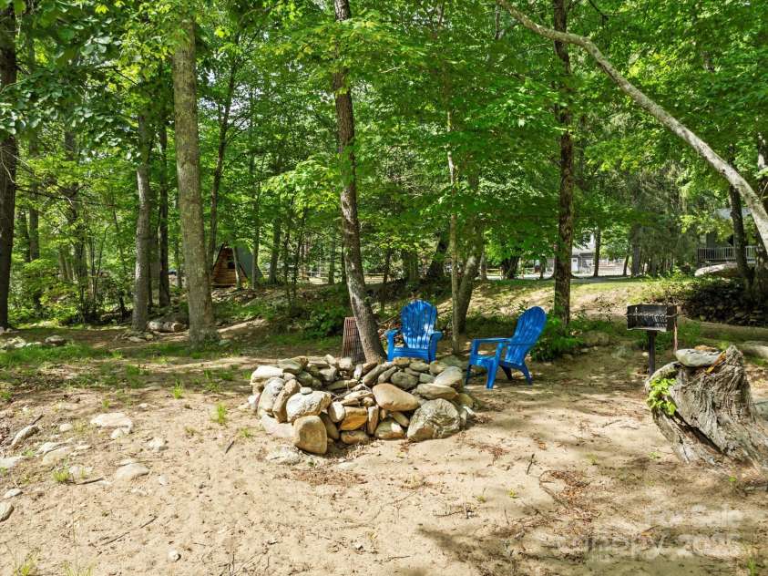 23 Mountain Meadow Lane, Canton, NC 28716.  MLS# CAR4269164, YatesRealty ID 18435. Enjoy a campfire or cookout on your private island! (Bridge was taken out by Helene & would need replaced