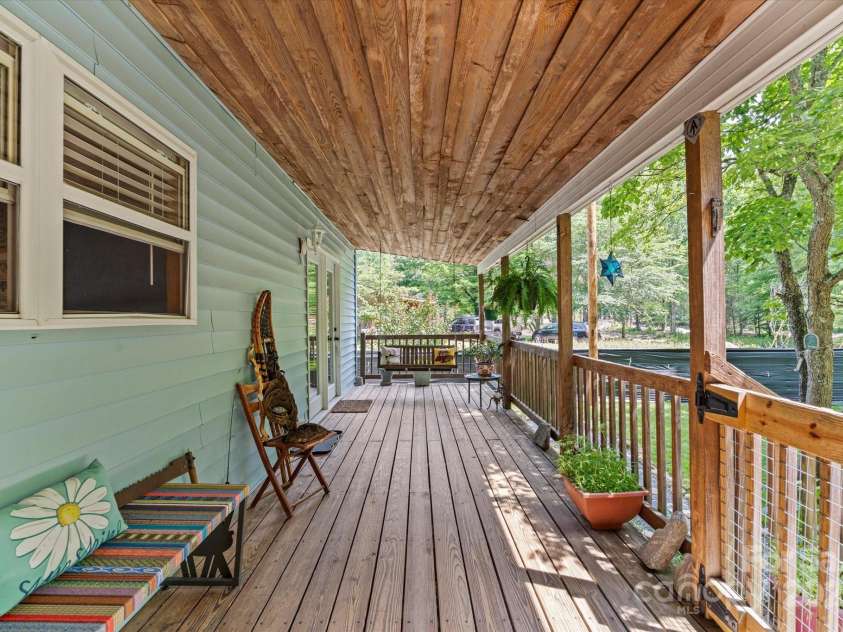 23 Mountain Meadow Lane, Canton, NC 28716.  MLS# CAR4269164, YatesRealty ID 18435. Enjoy the sound of the water from the expansive porch.