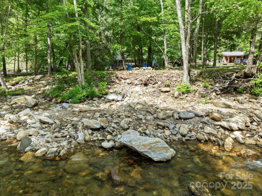 23 Mountain Meadow Lane, Canton, NC 28716.  MLS# CAR4269164, YatesRealty ID 18435. Looking towards the house from the river.