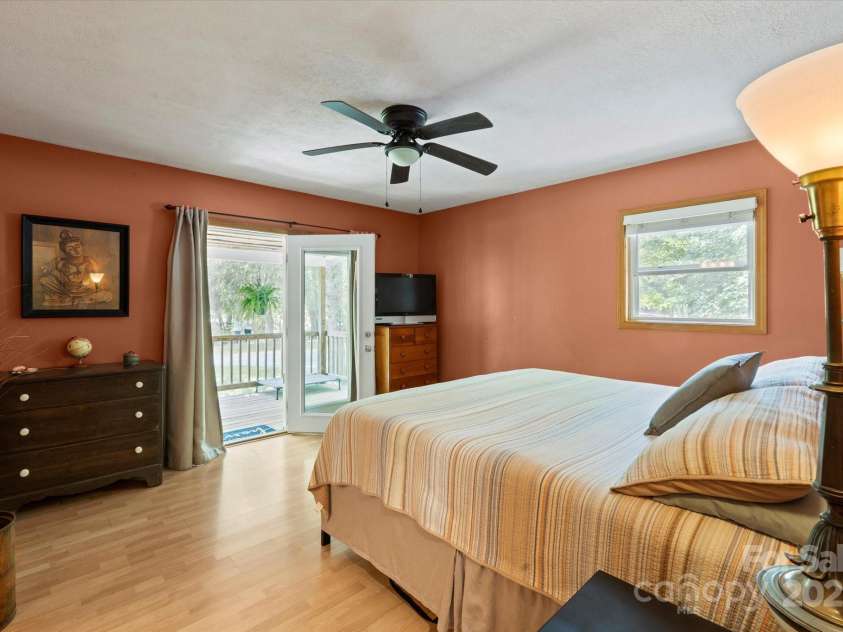 23 Mountain Meadow Lane, Canton, NC 28716.  MLS# CAR4269164, YatesRealty ID 18435. Primary bedroom with French doors to the front porch.