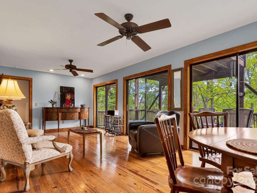214 Laurel Mountain Trail, Saluda, NC 28773.  MLS# CAR4259688, YatesRealty ID 18449. A wall of windows lets in so much light and the mountain breezes.