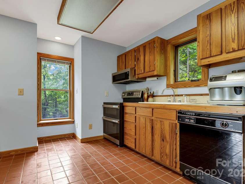 214 Laurel Mountain Trail, Saluda, NC 28773.  MLS# CAR4259688, YatesRealty ID 18449. Enjoy the views from the multiple windows while you cook.