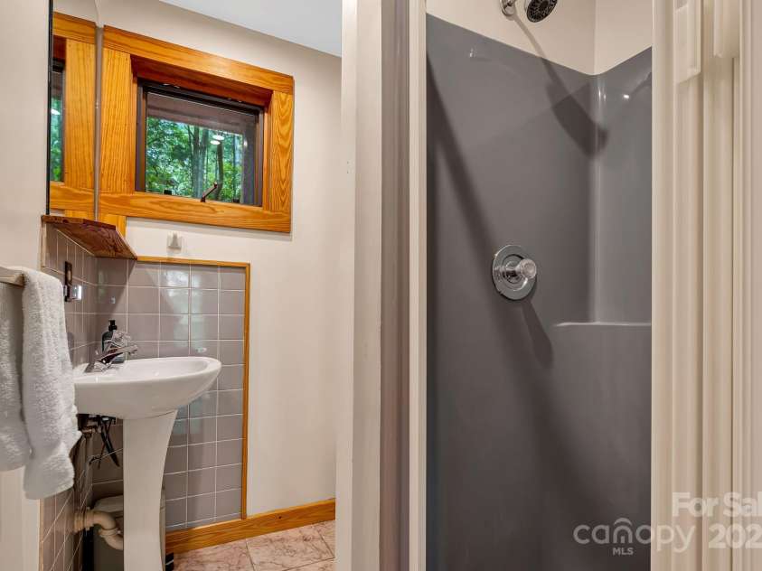 214 Laurel Mountain Trail, Saluda, NC 28773.  MLS# CAR4259688, YatesRealty ID 18449. First floor full bathroom with shower in the hall.