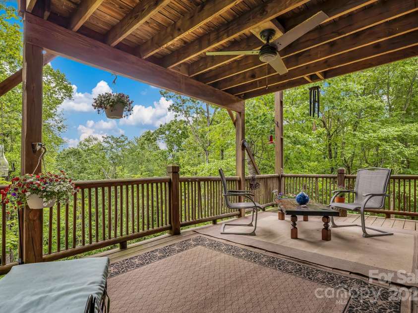 214 Laurel Mountain Trail, Saluda, NC 28773.  MLS# CAR4259688, YatesRealty ID 18449. The large covered deck doubles your living space.