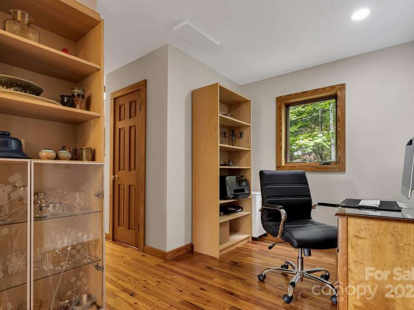 214 Laurel Mountain Trail, Saluda, NC 28773.  MLS# CAR4259688, YatesRealty ID 18449. There is a half bath behind the door.   This space could make a cozy breakfast nook or be used as an office as it is now.