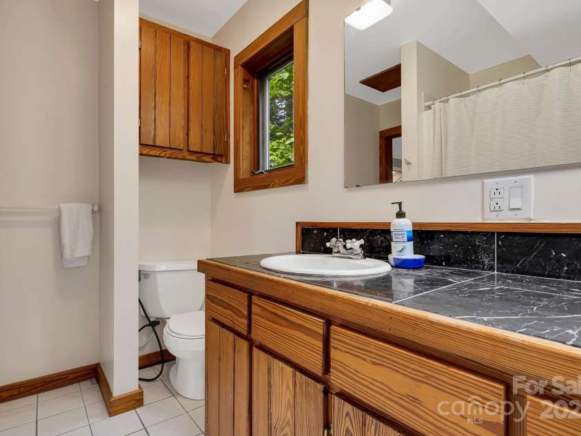 214 Laurel Mountain Trail, Saluda, NC 28773.  MLS# CAR4259688, YatesRealty ID 18449. This bathroom backs up to the wet bar and could be expanded if desired.
