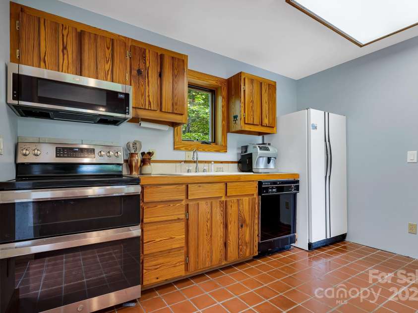 214 Laurel Mountain Trail, Saluda, NC 28773.  MLS# CAR4259688, YatesRealty ID 18449. This fully functional kitchen is ready for your updates.