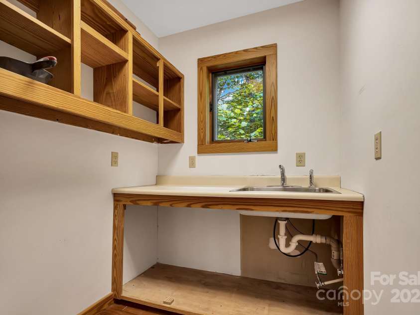 214 Laurel Mountain Trail, Saluda, NC 28773.  MLS# CAR4259688, YatesRealty ID 18449. This wet bar area with plumbing would be a great place to add an upstairs laundry room or expand the primary bathroom.