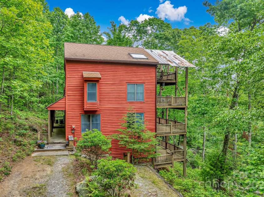214 Laurel Mountain Trail, Saluda, NC 28773.  MLS# CAR4259688, YatesRealty ID 18449. While there are some lovely plants on trees on the property, there is virtually no yard work.