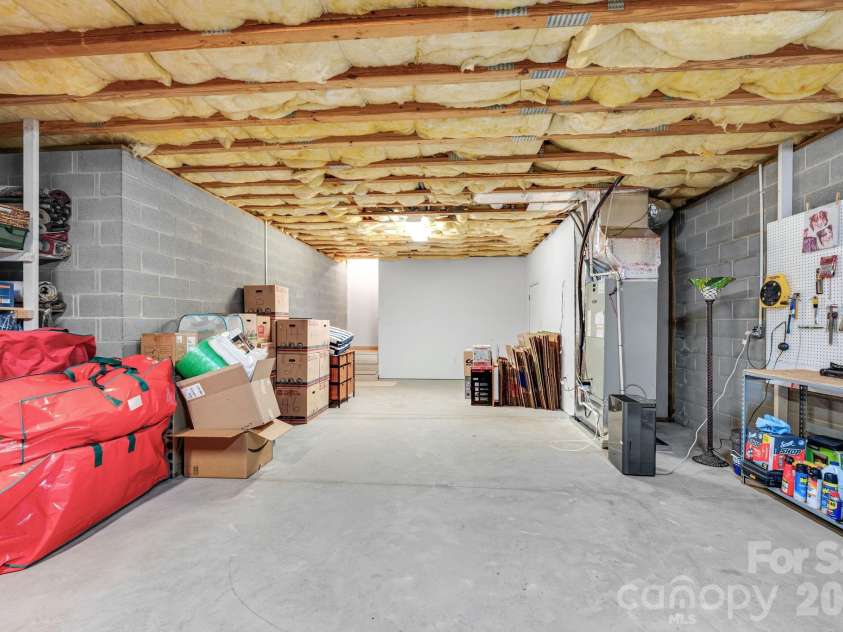 65 Lawson Ridge Road, Leicester, NC 28748.  MLS# CAR4352526, YatesRealty ID 18460. Basement storage utility space