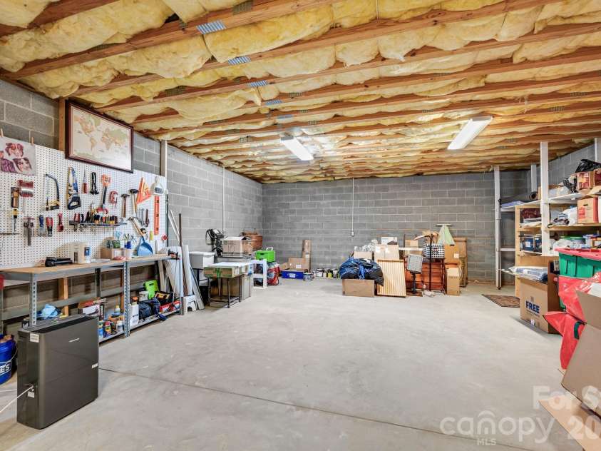 65 Lawson Ridge Road, Leicester, NC 28748.  MLS# CAR4352526, YatesRealty ID 18460. Basement workshop storage area