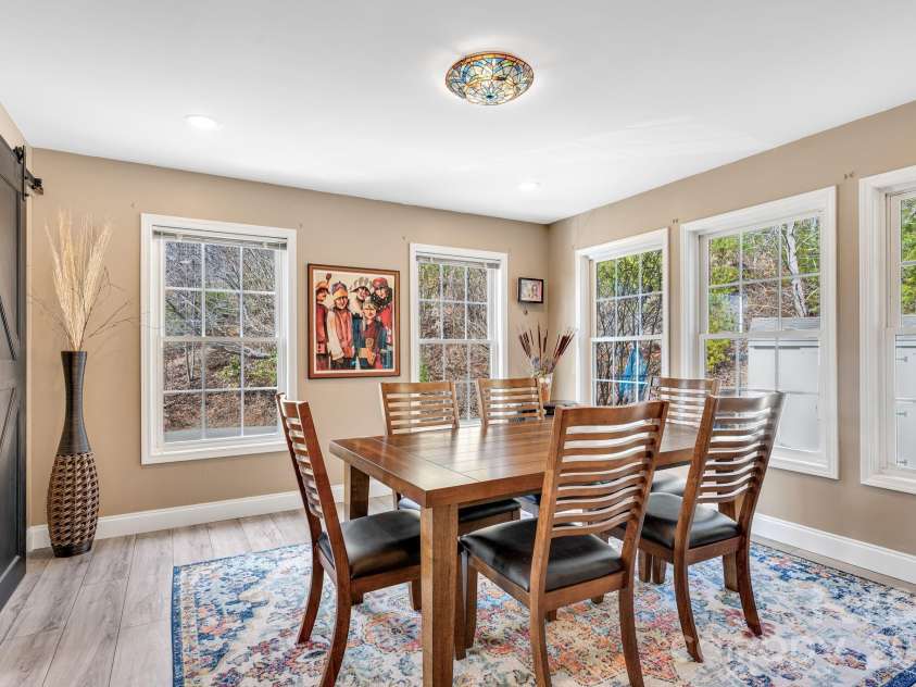 65 Lawson Ridge Road, Leicester, NC 28748.  MLS# CAR4352526, YatesRealty ID 18460. Bright Dining Area with Floor to Ceiling Windows